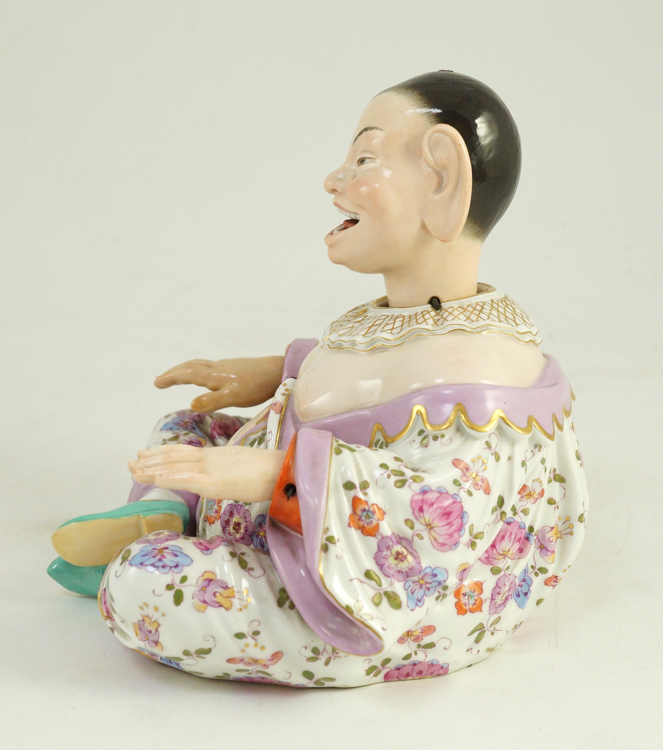 A Meissen figure of a nodding chinaman, 19th century, 17.5cm high, right hand restored